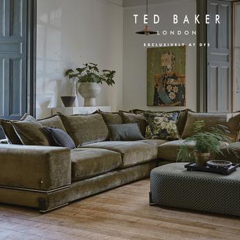 Dark green corner sofa with gold detailing with a dark green geometric footstool in a large living space