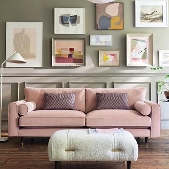 pink sofa with cream footstool infront