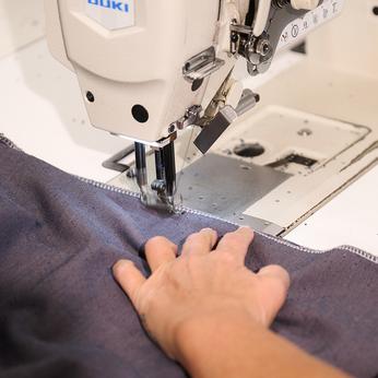 Close up of a women sewing fabric