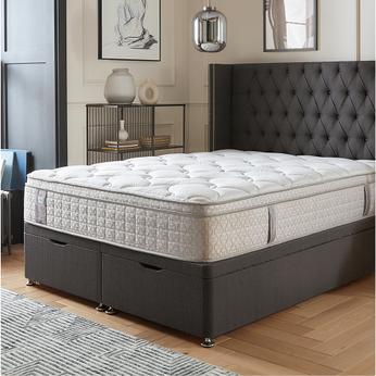 grey buttoned bed with a sealy mattress