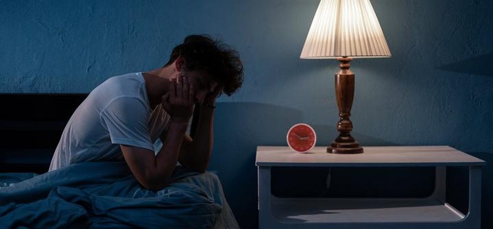 a man looking tired and awake with mental health