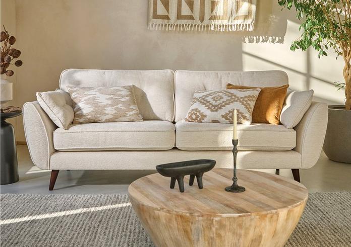 boucle sofa with beige and orange scatter cushions