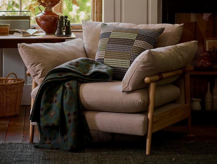 French Connection Hoxton chair with a green patterned scatter cushion and a green throw