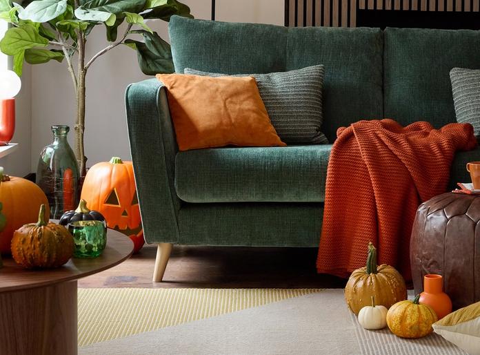 French Connection Carlisle sofa with autunmal and halloween decor or orange throws and scatters and pumpkins
