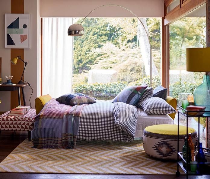 French Connection Zinc sofa bed in yellow in a space saving room next to a large bright window