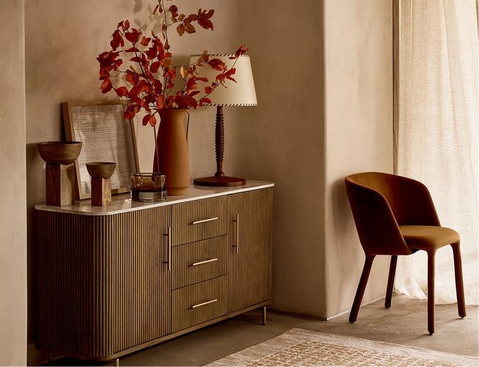 Dark brown sideboard with gold handles and a marble top 