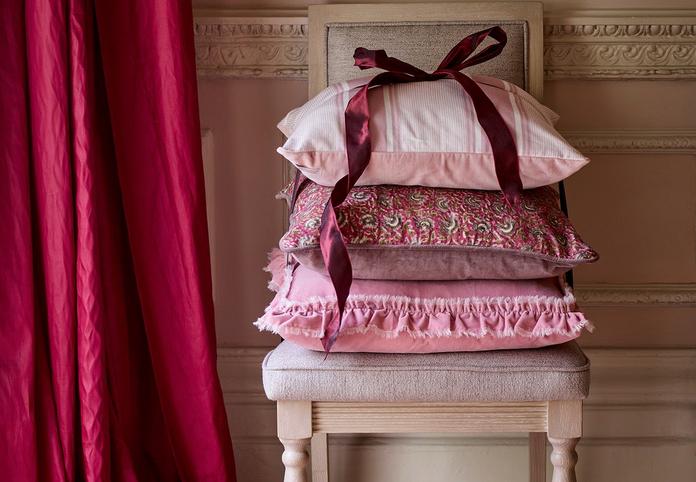 A pile of pink patterned scatter cushions
