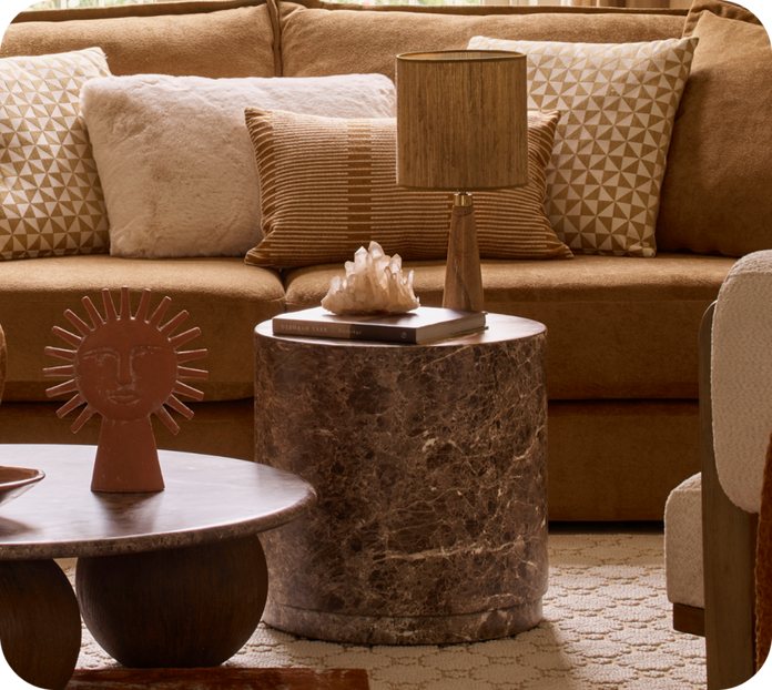 dark marble side table next to a brown sofa