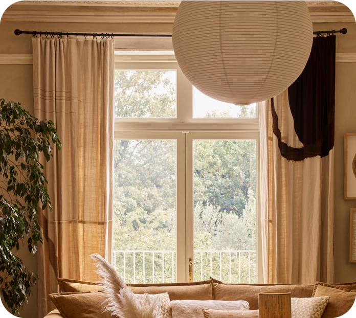 image of a window with long white curtains