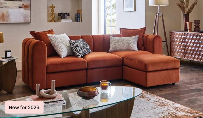 new sofables in plush in a dark but bright living space with walnut furniture