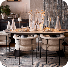 dining table and four white chairs with christmas decor