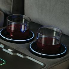Two glasses sat inside cupholders of a corner sofa