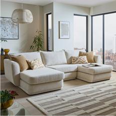 cream u shaped sofa with yellow scatters next to big windows