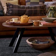 dark wood round coffee table with black metal angled legs