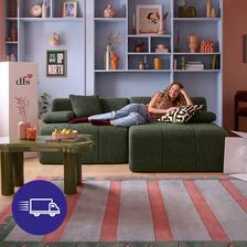 Women with blonde hair relaxing on a green sofa with boxes