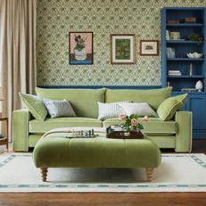 Joules Gilmorton sofa with matching footstool next to a green patterned wall