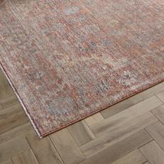 persian style rug with orange, cream and brown
