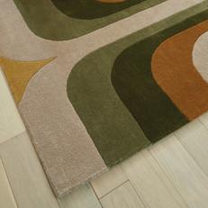 a retro inspired patterned rug with orange yellow green and brown