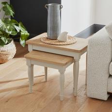 Two tone nest tables with white legs and oak top next to a white sofa