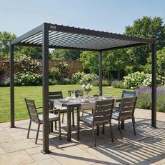 Grey metal pergola with match garden outdoor furniture in a sunny garden