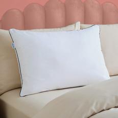 Close up of a thick Siletnight pillow on a pink scalloped bed
