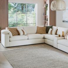 platinum lenora corner sofa with orange and cream scatter cushions