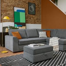 dfs orka sofa with orange and monochrome cushions against an orange wall