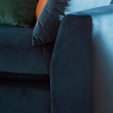 Navy blue velvet fabric with orange and green velvet scatter