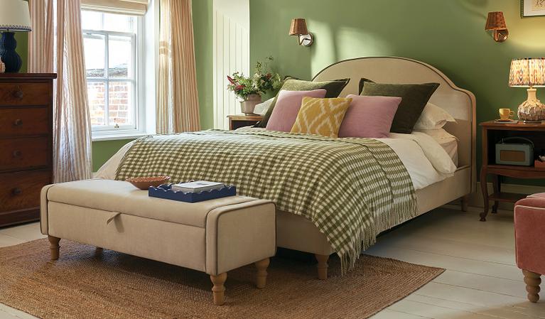 cream bed with olive green check throw