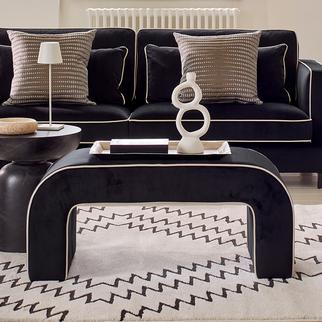 Black banquette footstool with white piping detail