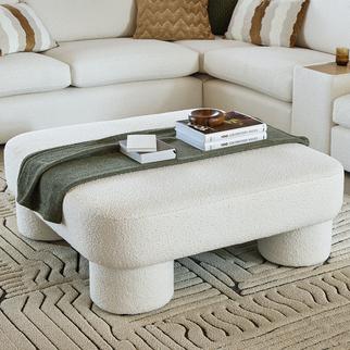Cream oversized footstool with cured round feet