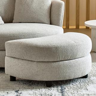 Light grey half moon footstool on a fluffy white rug