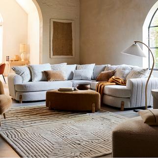 boucle curved sofa in a neutral cosy living space