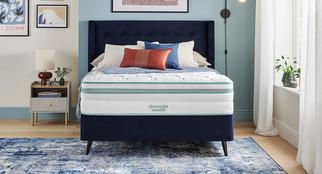 Silentnight Pocket Sprung mattress on a navy blue divan bed with dark wooden legs on a blue patterned rug