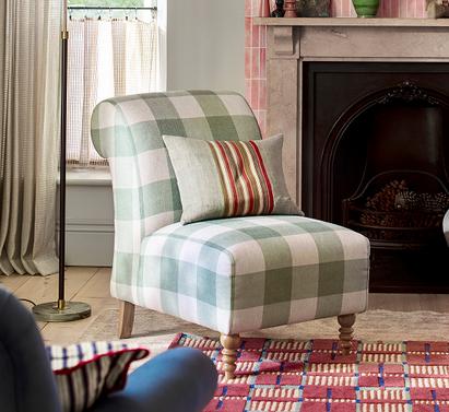 Country Living Arundel green and white plaid style accent chair with wooden feet on a pink patterned rug with sage green scatter cushion