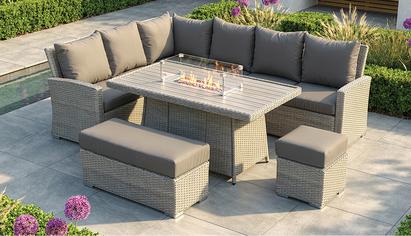 Grey rattan garden corner sofa with a rising table and built in fire pit