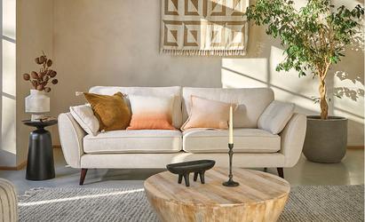 Sunlit neutral living room with a cream sofa with calm, inviting decor.