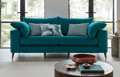 Teal sofa with black with patterned teal and white scatters