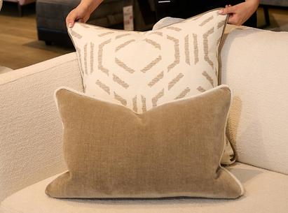 Close up of a women turning a brown and brown patterned scatter cushions