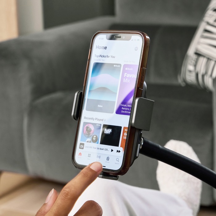 close up of someone using a mobile phone on a phone mount