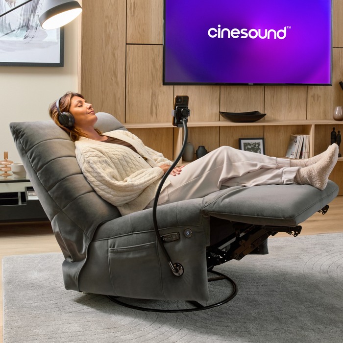 women reclined on a swivel chair relaxing with headphones on