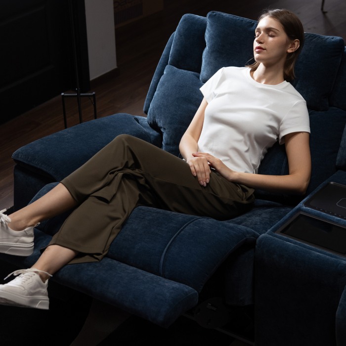 young women sleeping on a reclined sofa