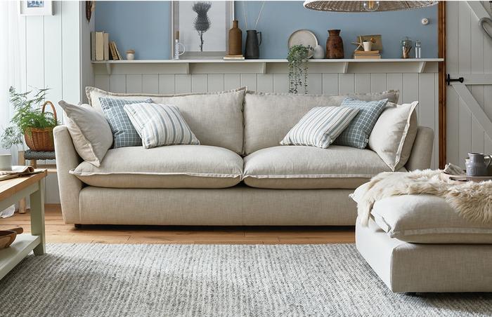 fabric cream sofa in a cottage style living room with a grey rug