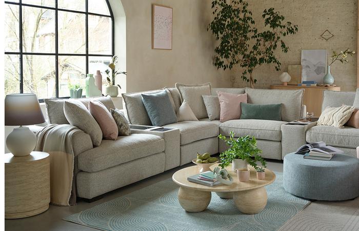 cream corner sofa with pink and blue scatter cushions
