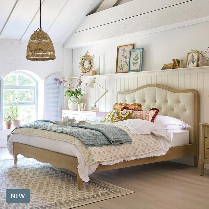 Country Living Monmouth bed next to a white panelled wall