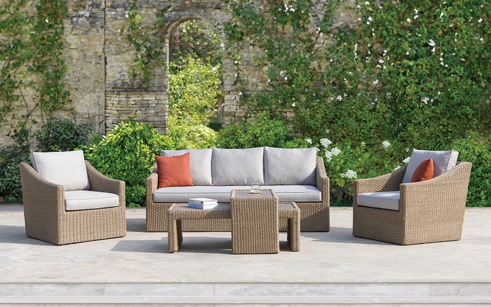 brown rattan sofa set with 3 seater sofa, two chairs and a table