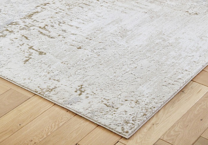 close up of a cream rug on a wooden floor