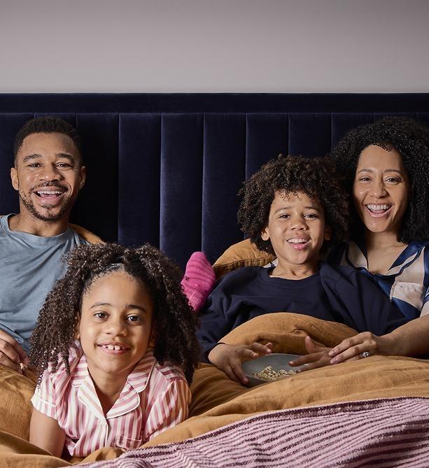 Family watching a film together in a Cinesound bed