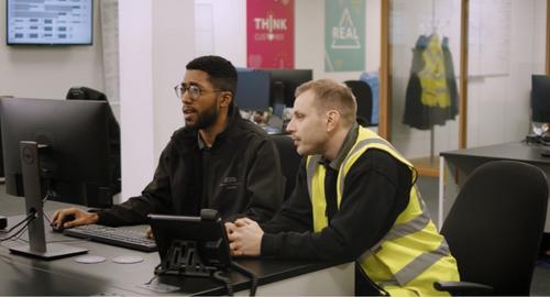 Two men working at a computer