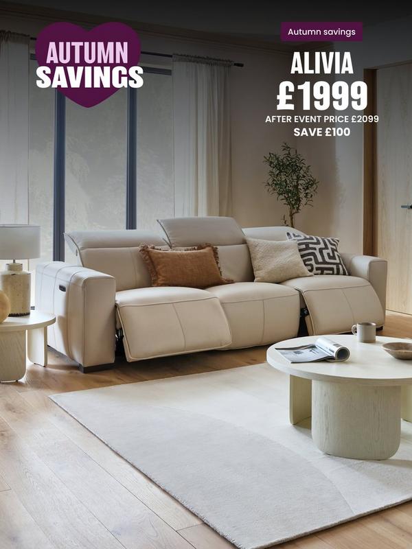 Cream leather recliner sofa with complimenting scatter cushions in neutral room